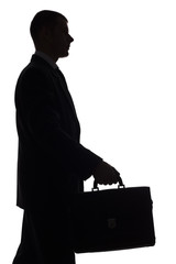 silhouette of man with suitcase