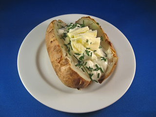 baked potato with sour cream, butter and chives