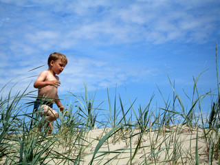 boy running in dunes