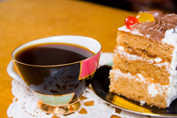 cup of coffee and slice of creamy cake