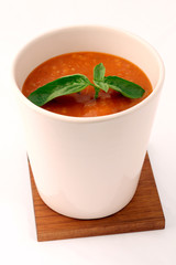 tomatoe soup with basil in white cup