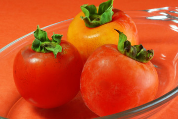 persimmons in glass dish
