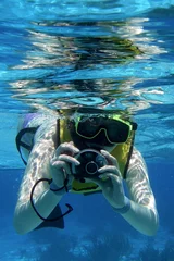 Wall murals Diving snorkler with camera