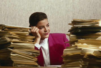 woman in office overwhelmed by paperwork