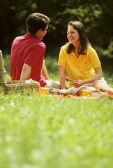 young couple have picnic in park