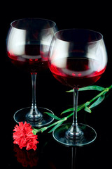 wine glasses and a red flower
