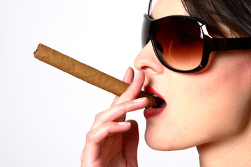 dark hair woman smoking a cigar with sunglasses