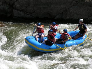 group of friends white water rafting in colorado.