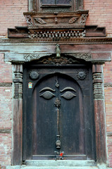 nepalese carved wooden doorway with buddha’s eyes