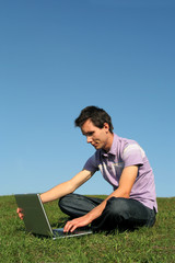 young man using a laptop outdoors