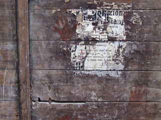 poster remains on wooden surface