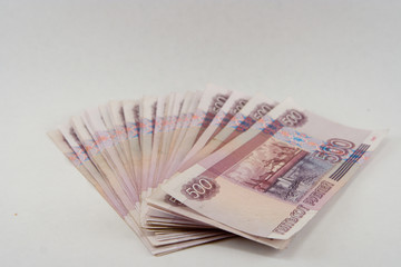 pile of monetary denominations on a white background