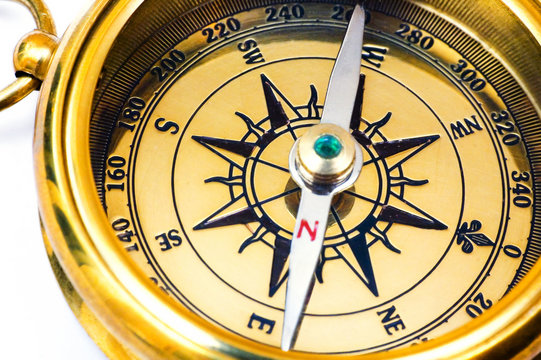 old style gold compass on white background