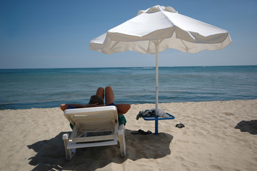 man, umbrella and sunbed