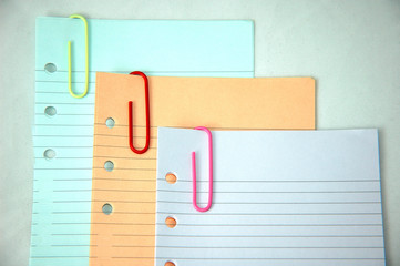 cloured paper clips and paper