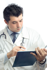 young physician writing down notes in a notebook