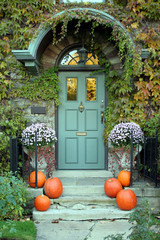 front door with ivy and pumpkins