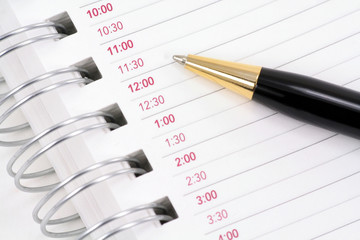 opened notepad with pen