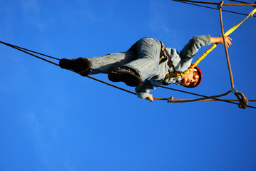 boy standing on a steel wire