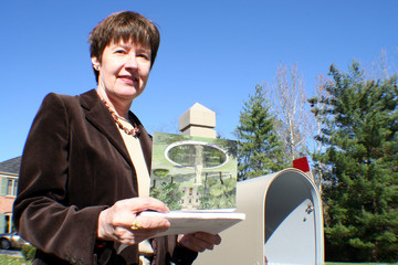 woman with letter at mailbox