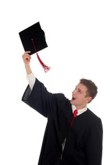 young man tossing up his hat on graduation day