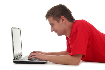 man lying on floor using laptop