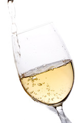 white wine being poured in a glass