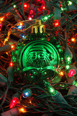 green christmas ball in christmas lights
