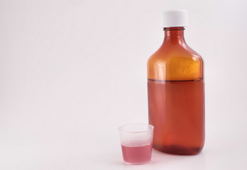 cough syrup with measuring cup