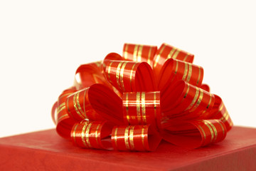 red ribbon and gift box over white background