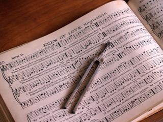 shaped note hymnal with song leader's tuning fork