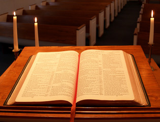 bible on pulpit with candles