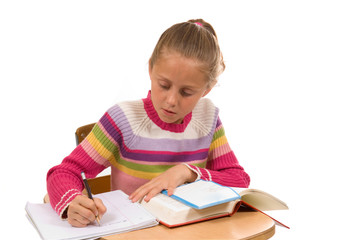 young girl at desk in school on white