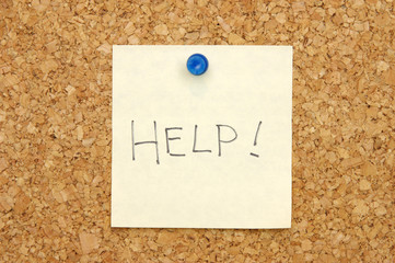 note on corkboard asking for help