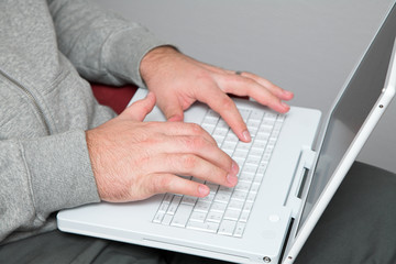 Fototapeta na wymiar hands of a man on laptop keyboard