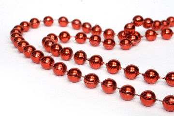 red beads in shape of heart on white