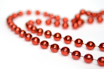 red beads in shape of a heart isolated on white