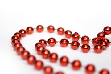 red beads in shape of heart isolated on white