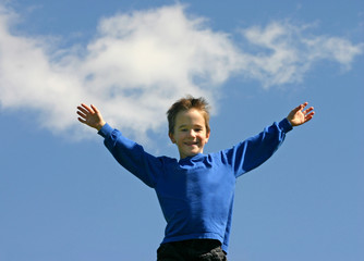 Fototapeta na wymiar boy happy in cloudy blue sky
