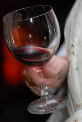 glass with red wine in hand.