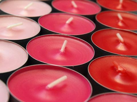unlit votive candles in shades of red