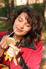 a closeup of a woman putting on lip liner.