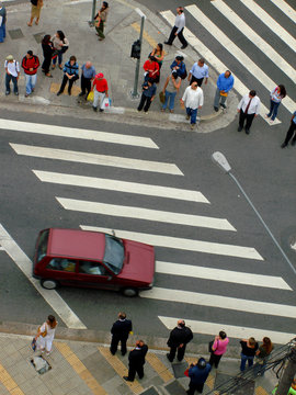 red car with pedestrians