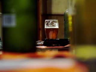 pint of half drunk beer on pub table