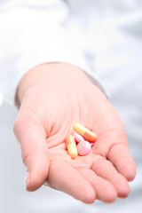 woman holding pills