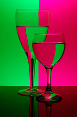 two glasses on neon background