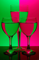 three glasses on neon background