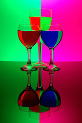 three glasses on neon background