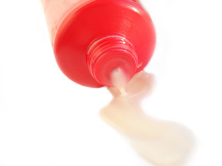 red shampoo bottle on a white background