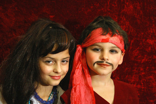 the boy and the girl in suits (pirate and gipsy).